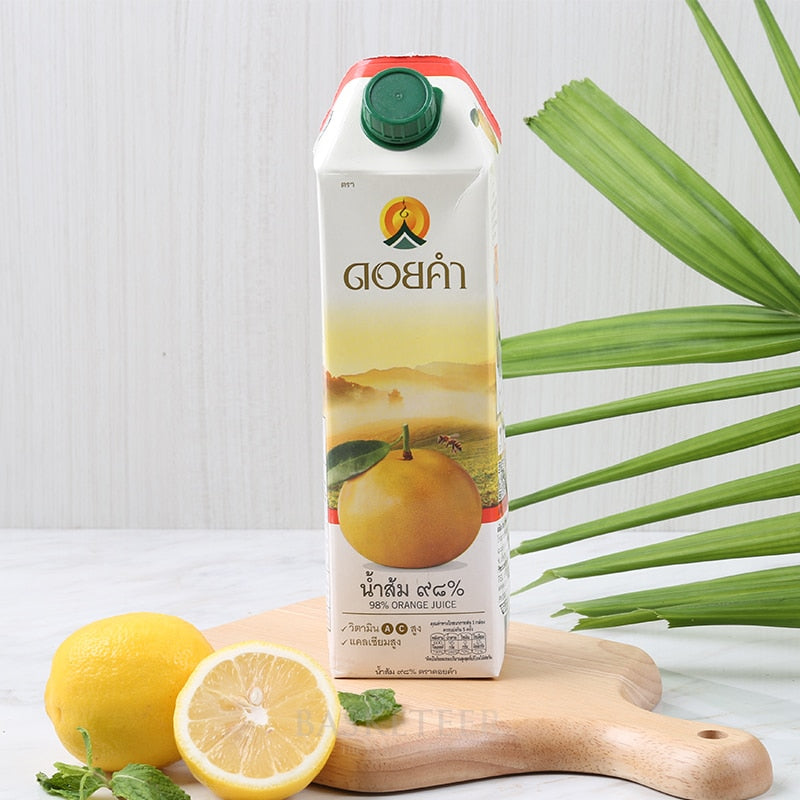 Premium 98% orange juice carton with fresh lemons and mint on wooden board
