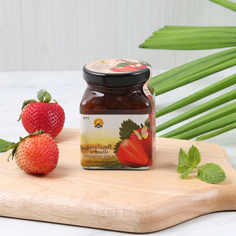 Premium Doi Kham strawberry jam jar with fresh berries and mint on rustic wooden board