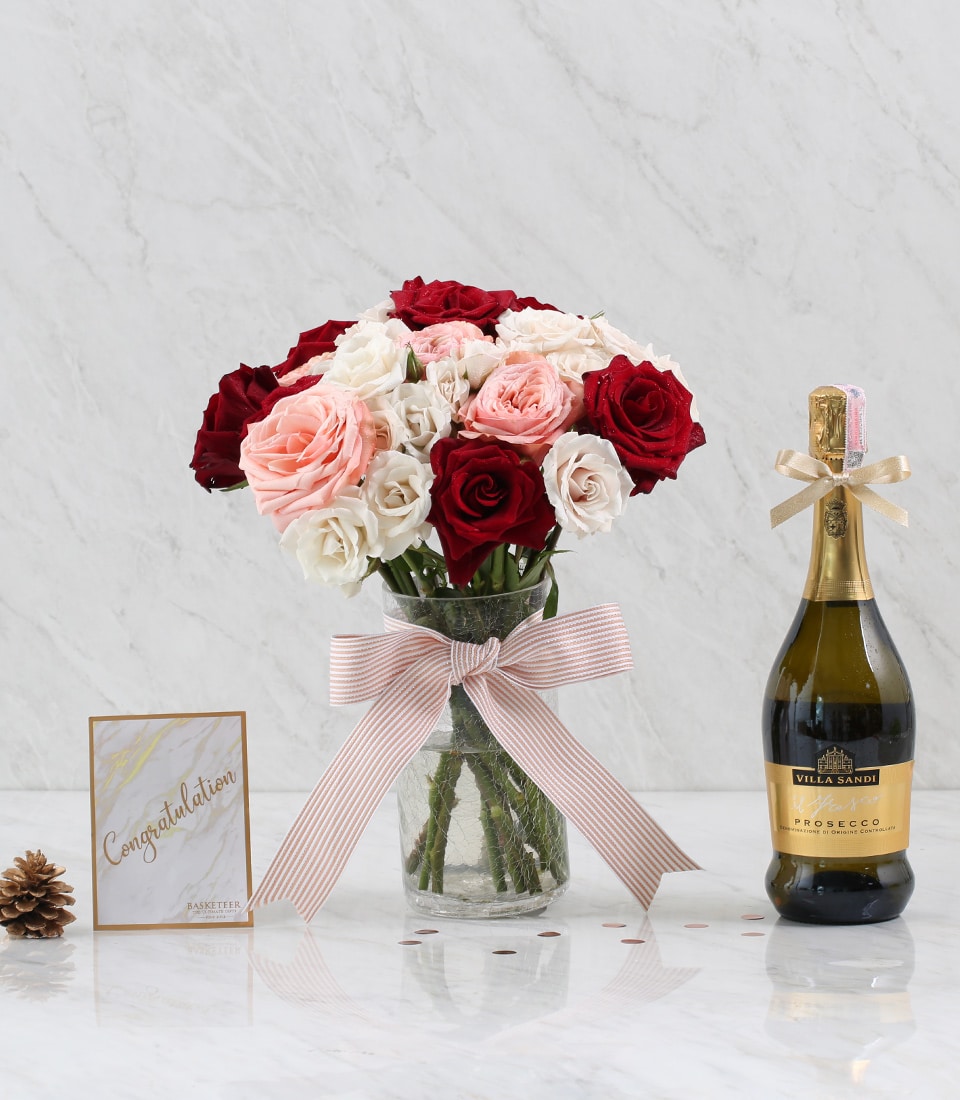 Premium red and pink roses in glass vase with Villa Sandi Prosecco, gold ribbon, and greeting card