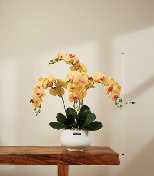 Vibrant golden yellow artificial orchids with pink centers in white ceramic planter, 70cm height