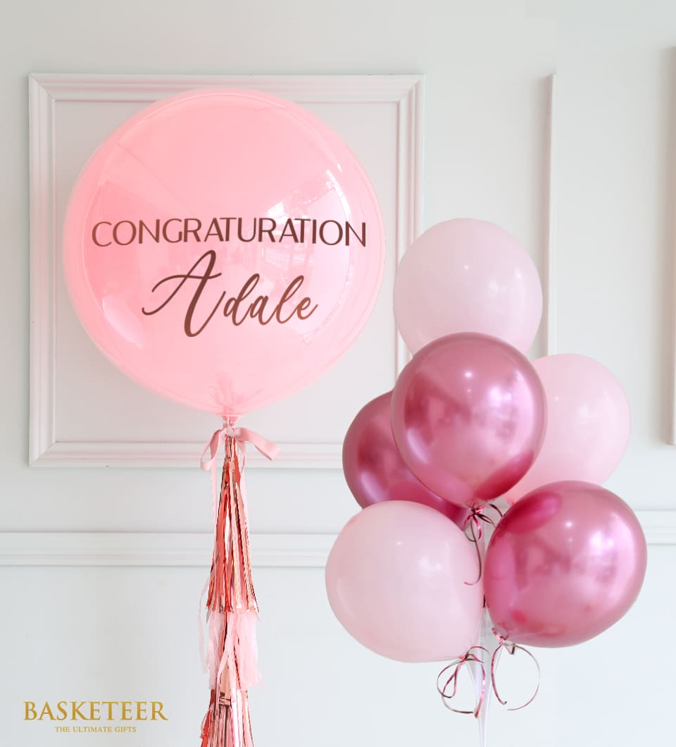 Pink balloon gift set with personalized bubble balloon and rose gold accents for celebrations