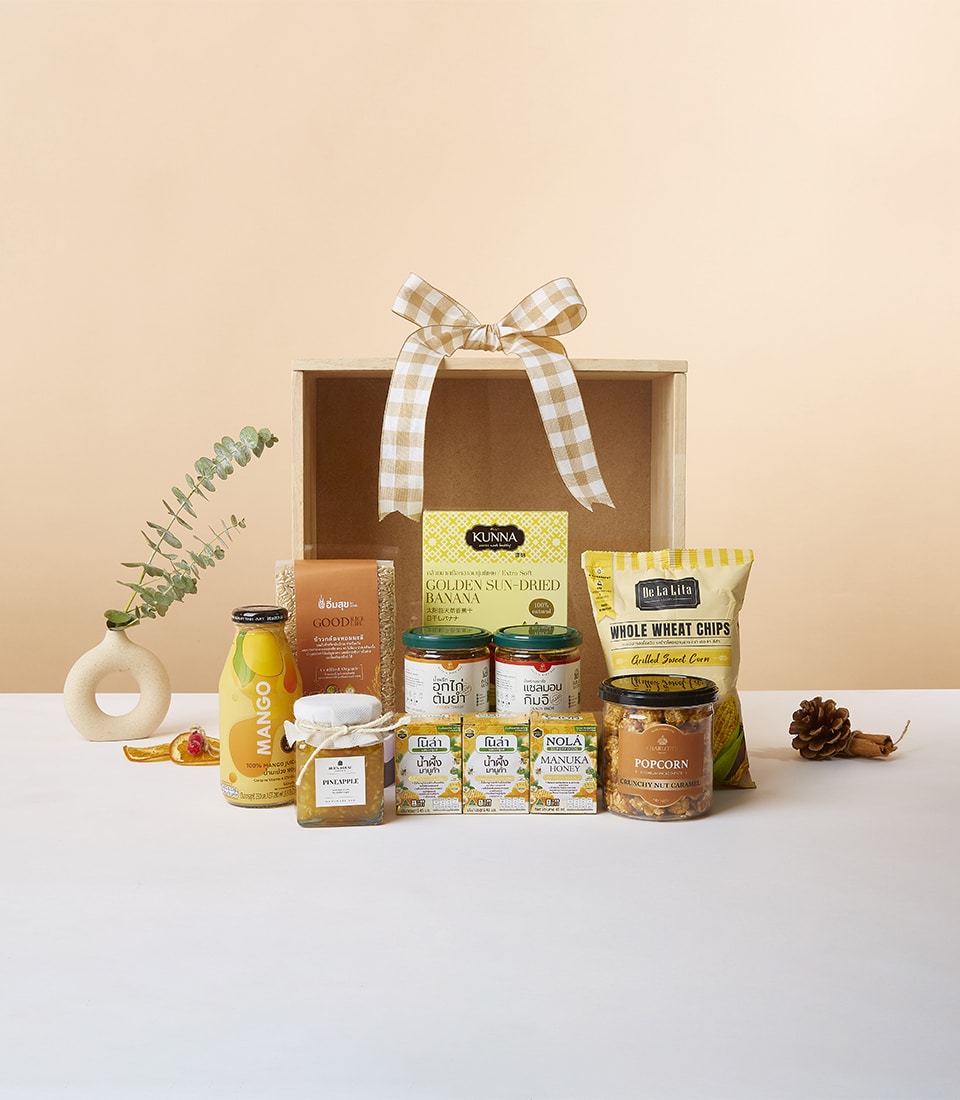 Wellness Wonders wooden gift box with sun-dried banana, whole wheat chips, caramel popcorn, mango juice, honey, and preserves