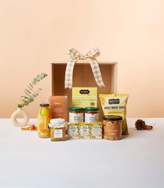 Wellness Wonders wooden gift box with sun-dried banana, whole wheat chips, caramel popcorn, mango juice, honey, and preserves