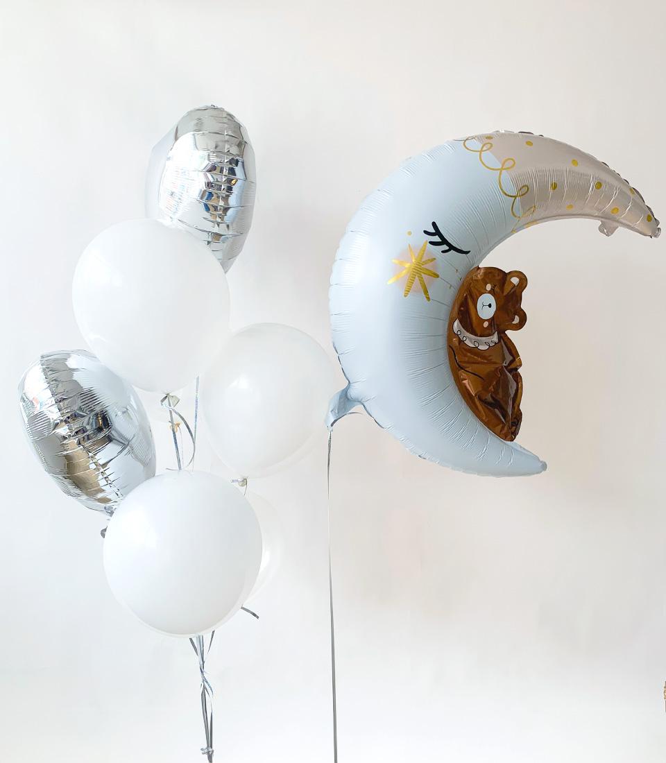 Blue crescent moon balloon with sleeping face and teddy bear, paired with silver star and heart foil balloons for kids'