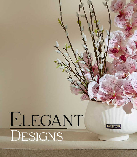 Light pink speckled orchids and pussy willow in white ceramic vase, elegant artificial flower arrangement