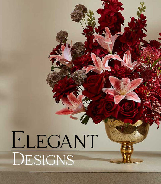 Luxurious crimson and blush artificial flower arrangement in gold mercury glass footed bowl with roses, dahlias, and lilies