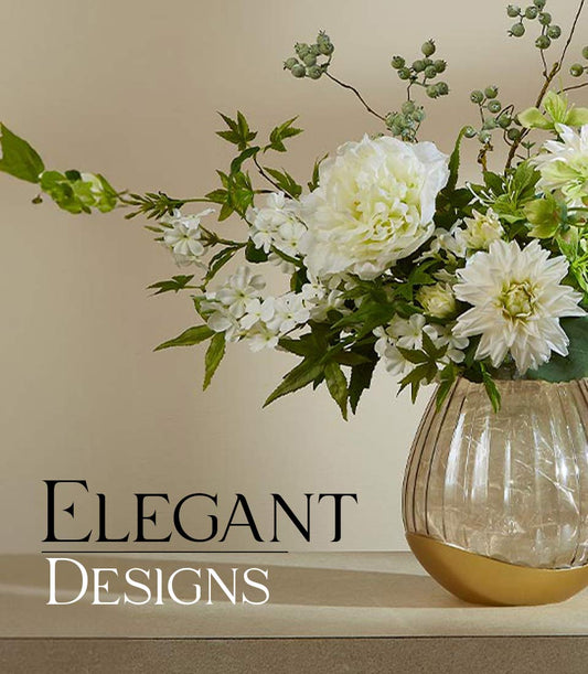 White peony and jasmine artificial flower arrangement in amber glass vase with gold base