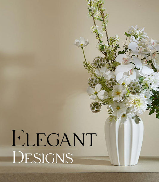 Tall white ceramic vase with elegant white orchids, dahlias, and green foliage artificial flower arrangement