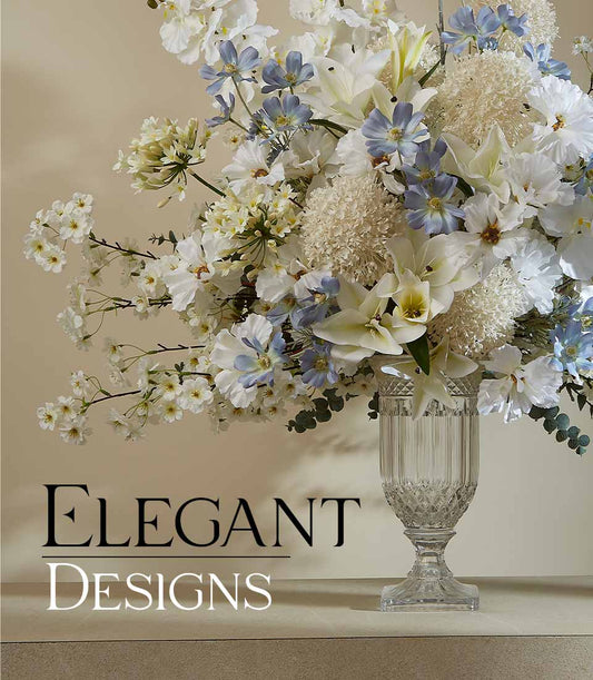Ethereal white and light blue artificial flower arrangement in cut-glass fluted vase