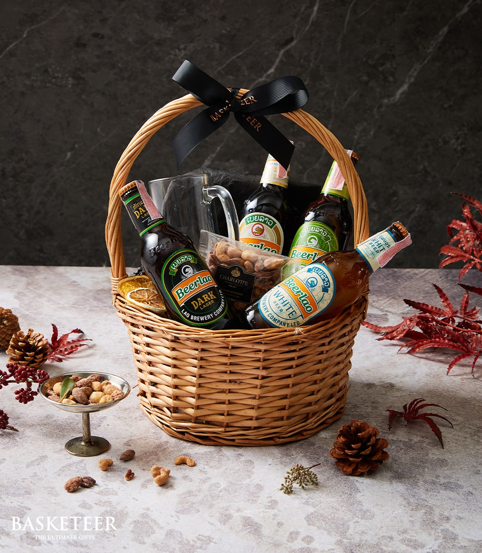 Beerlao craft beer gift basket with lager bottles, beer glass, and roasted nuts in woven wicker