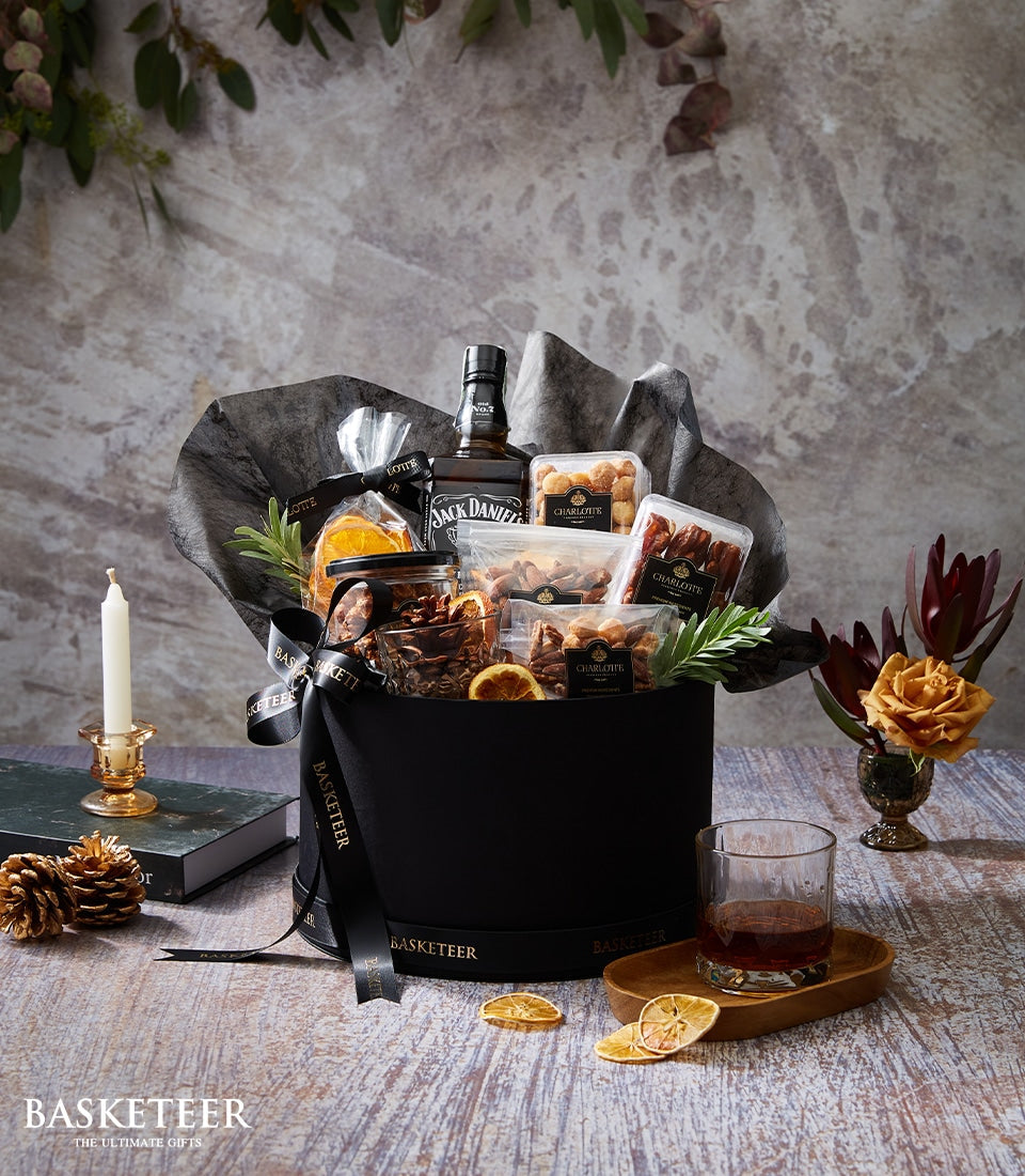 Premium whiskey gift set with gourmet nuts, dried fruits, and artisan confections in luxury black box