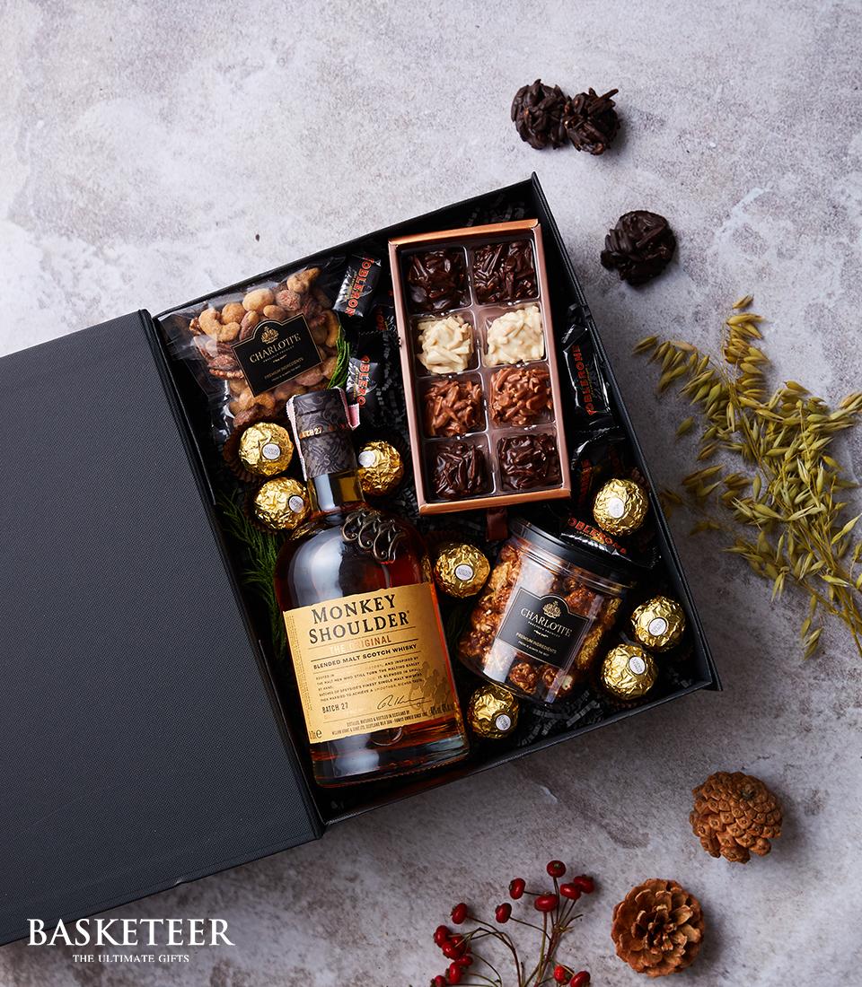 Monkey Shoulder whisky luxury gift box with chocolates, nuts, and caramel popcorn in black presentation box