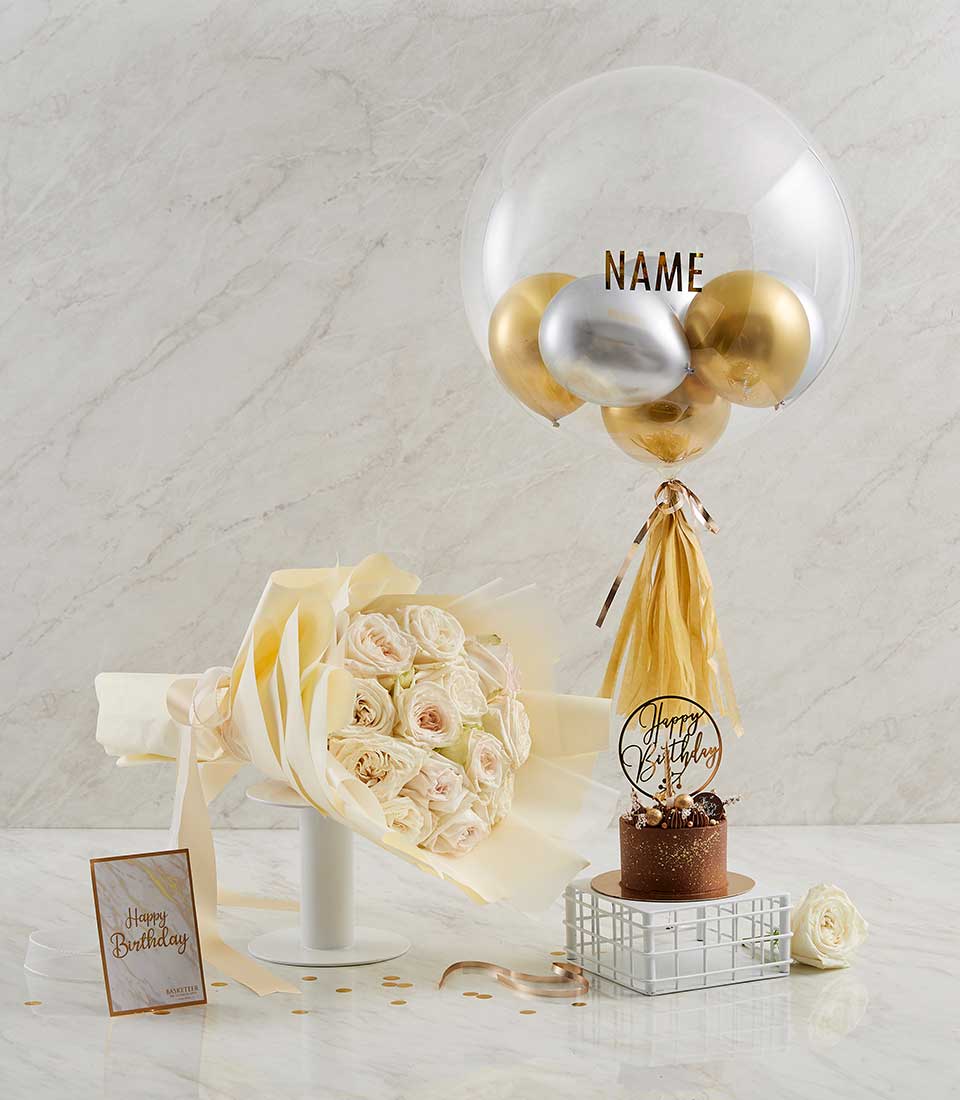 Luxury birthday gift set with personalised bubble balloon, pink roses, and chocolate cake with gold accents