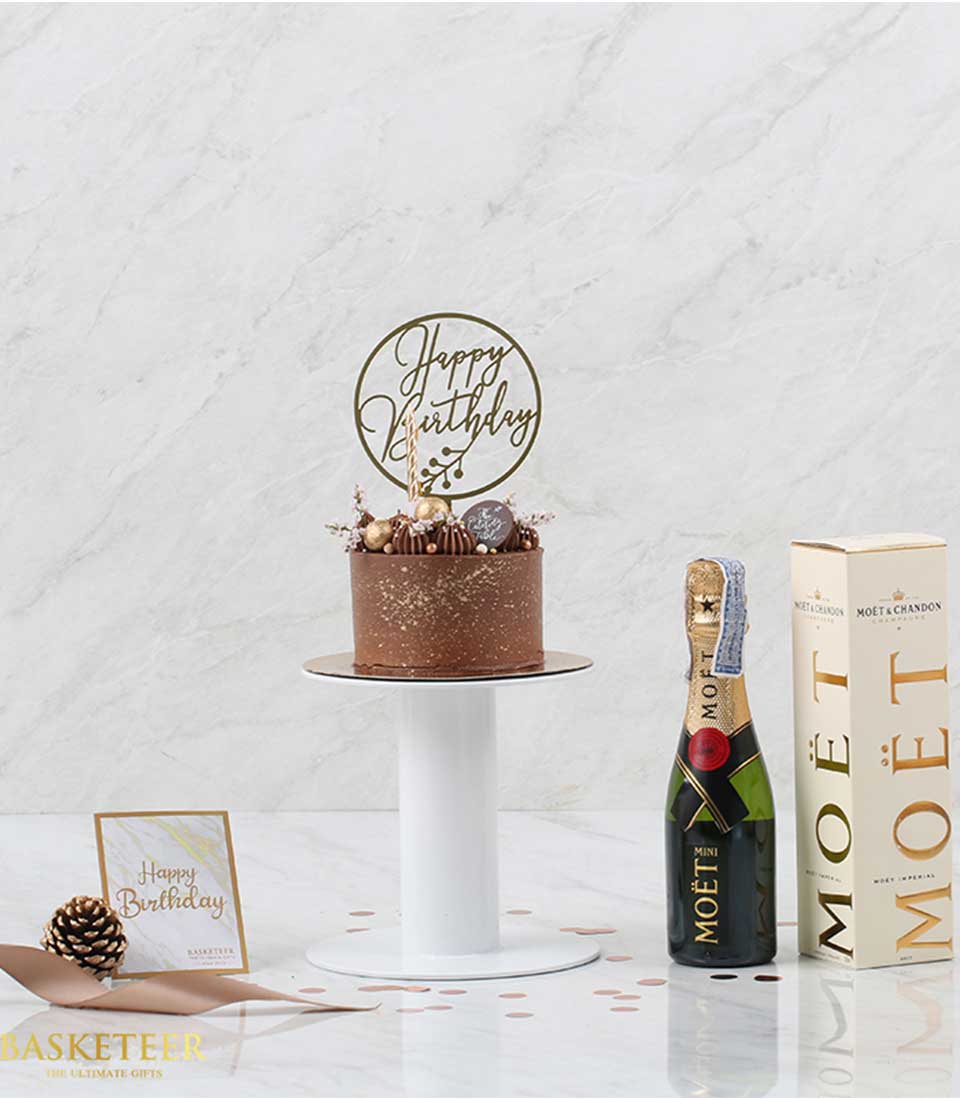 Chocolate cake with gold sprinkles and champagne gift set for birthday celebrations
