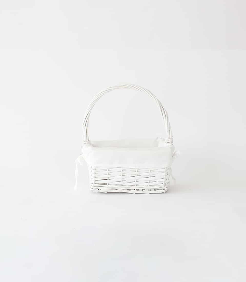 White wicker gift basket with fabric liner and handle, ready for artisan gifting