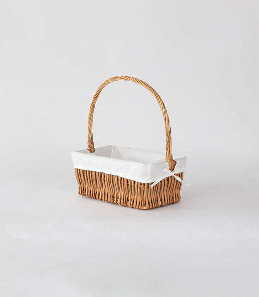 Light brown woven storage basket with cloth lining and arched handle for luxury gift hampers