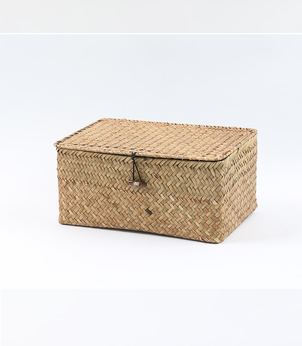 Woven seagrass storage basket with wooden toggle closure in natural tan
