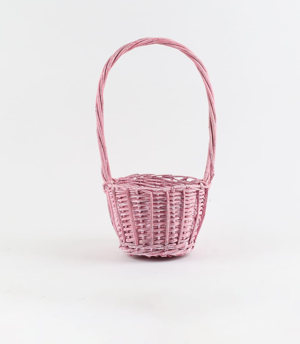 Soft pink rattan basket with arched handle, handcrafted woven design for luxury gifting