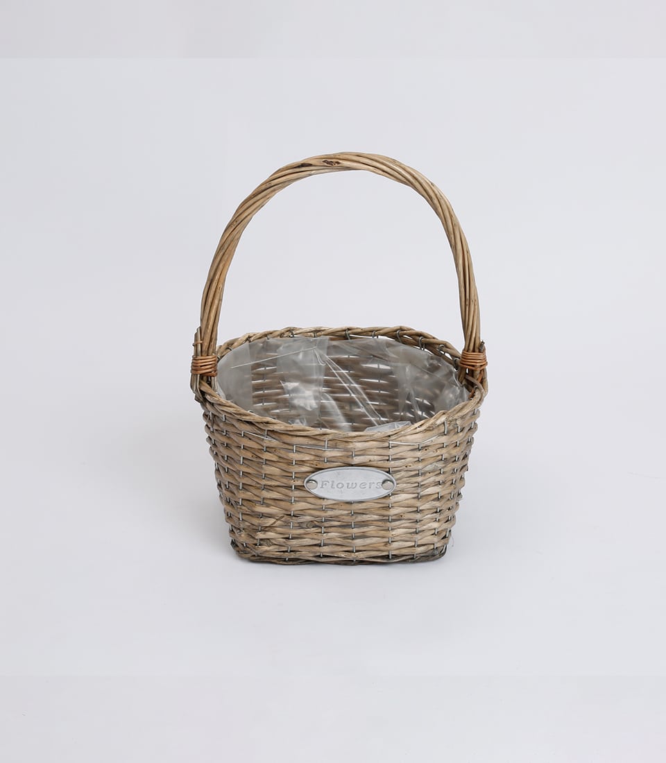 Light brown wicker basket with arched handle, ready for fresh flowers or plants