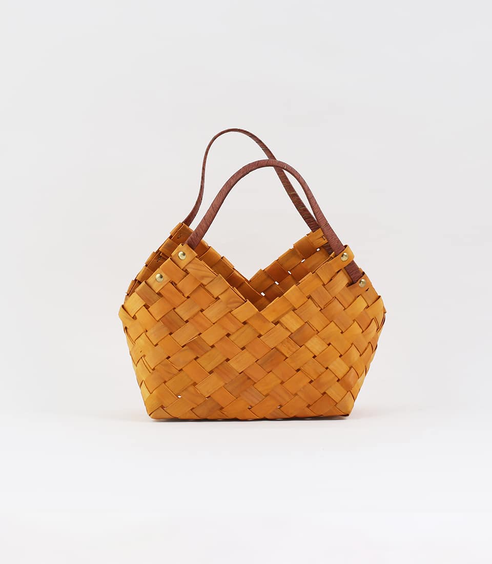 Natural woven wooden basket with brown leather handles and brass rivets, ready for custom gift curation