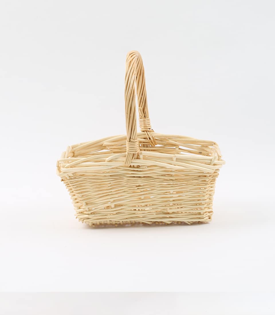 Light tan wicker gift basket with arched handle, handcrafted willow weave for luxury gift hampers