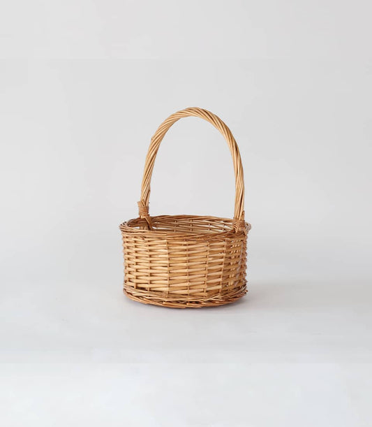 Light brown wicker hamper with arched handle, handcrafted for premium gift presentations