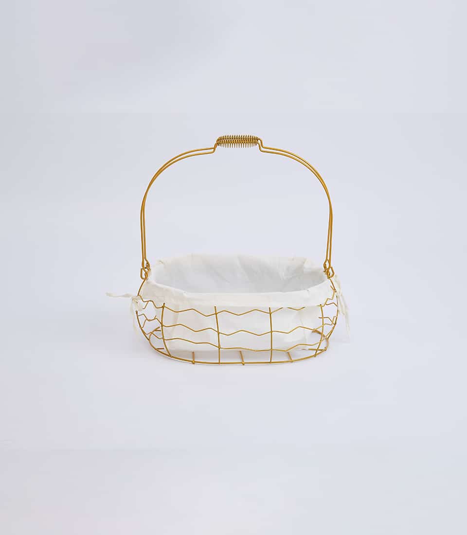 Gold-framed oval basket with white linen liner and curved handle for gifting