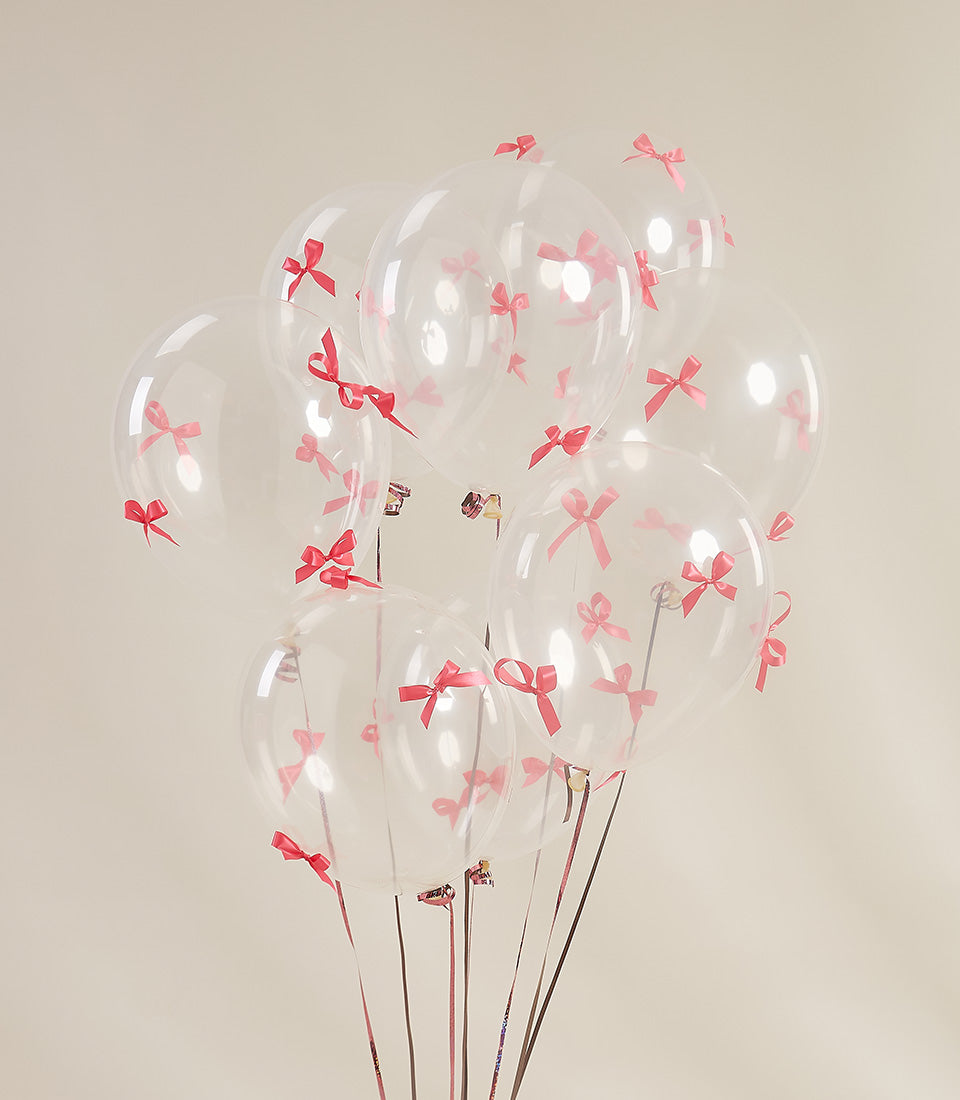 Clear balloons with pink and red ribbon bows, luxury gift surprise arrangement for gifting occasions