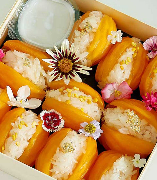 Mango sticky rice with mung beans and edible gold in artisan gift box, tropical Thai dessert