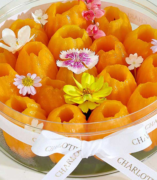 Peeled Mayongchid tropical fruits gift box with white ribbon and colorful flowers
