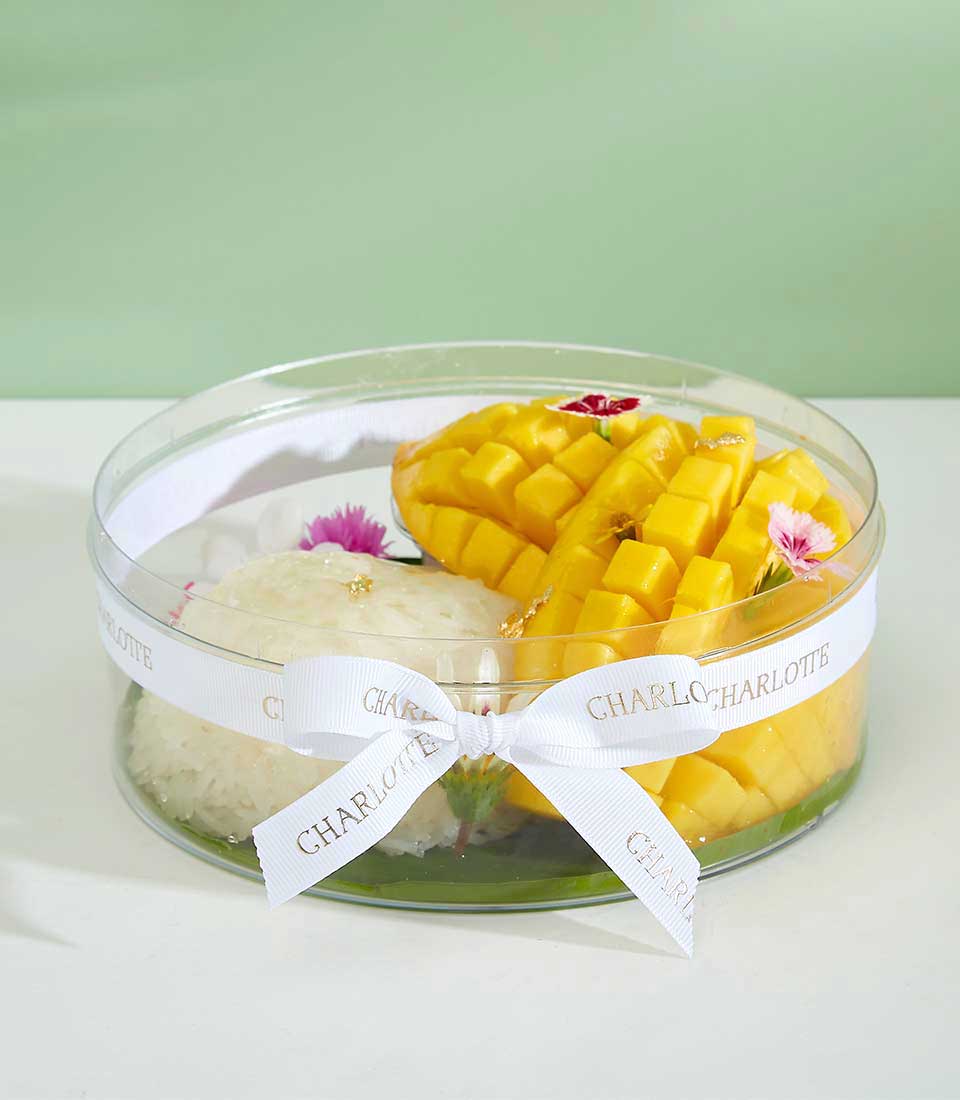 Luxury mango sticky rice gift box with edible gold leaf and fresh tropical mango, artisan baked treat from Charlotte Bakery