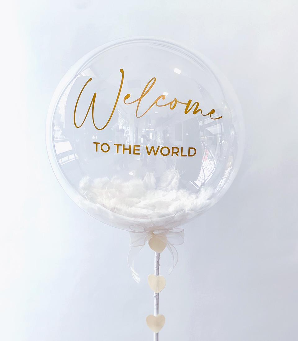 Welcome to the World balloon gift with white feathers and heart embellishments