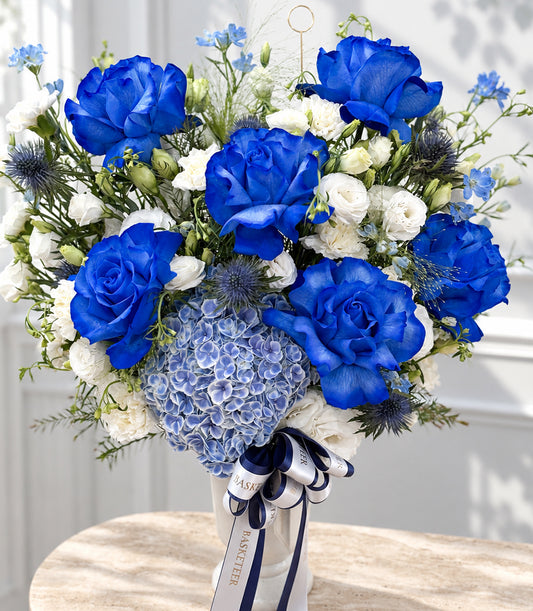Elegant blue rose and hydrangea vase arrangement by Flowers by Basketeer, featuring