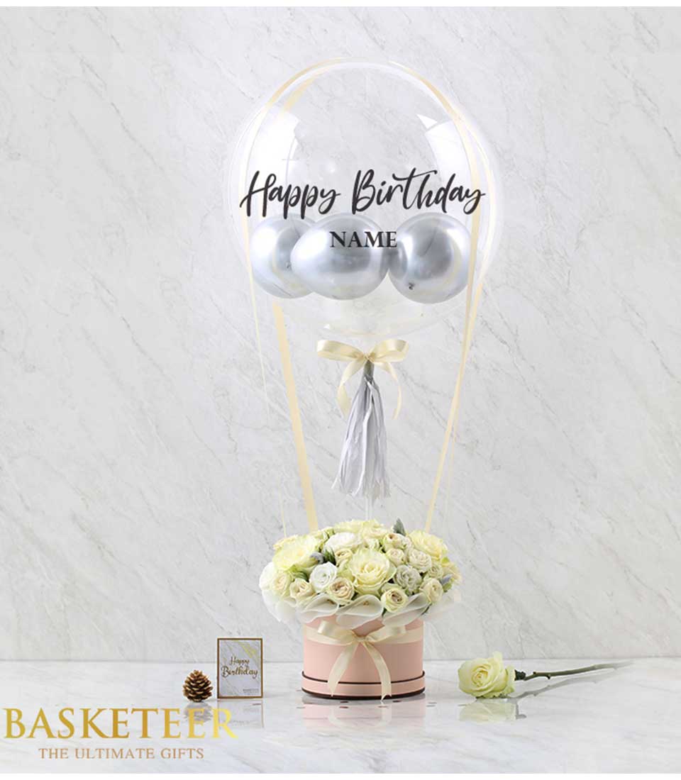 White roses with silver balloons, light pink hatbox, gold ribbons, personalized clear balloon for birthday gift combo