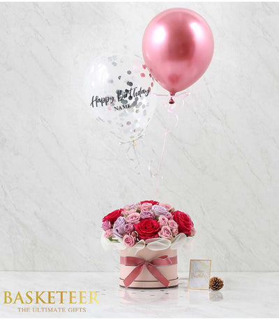 Pink roses and mixed florals in hatbox with confetti balloon birthday gift arrangement