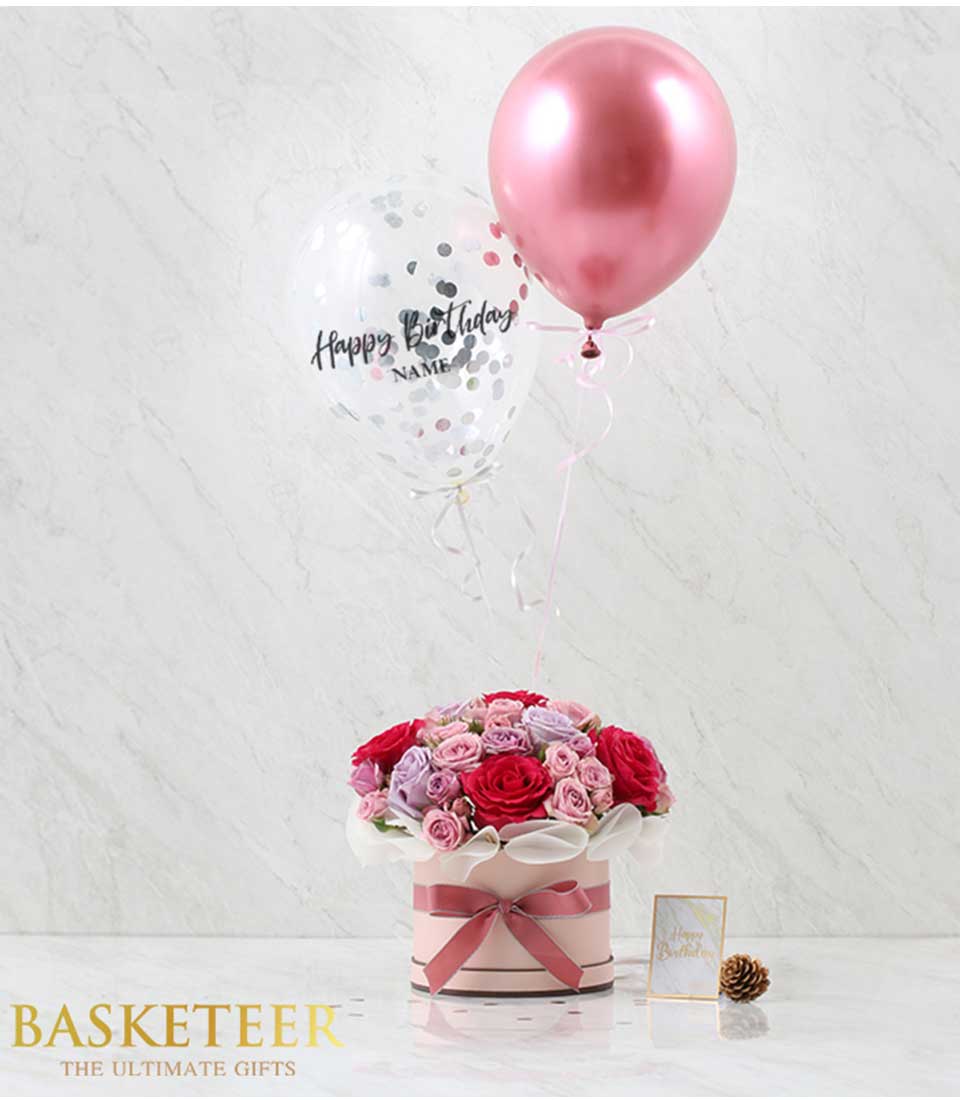 Pink roses and mixed florals in hatbox with confetti balloon birthday gift arrangement
