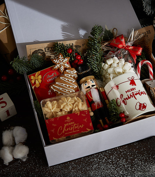 Festive Indulgence white gift box with chocolate, gingerbread cookies, butter cookies, nutcracker, mug and candy cane