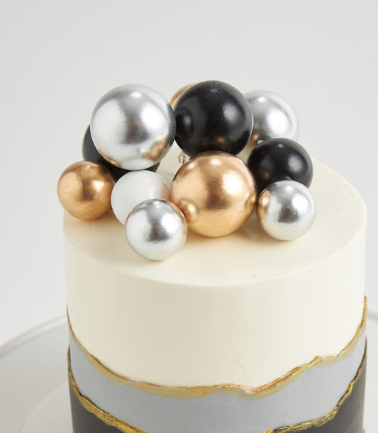 Luxe Black Forest birthday cake with metallic sphere tiers, gold accents, and modern grey ombré design