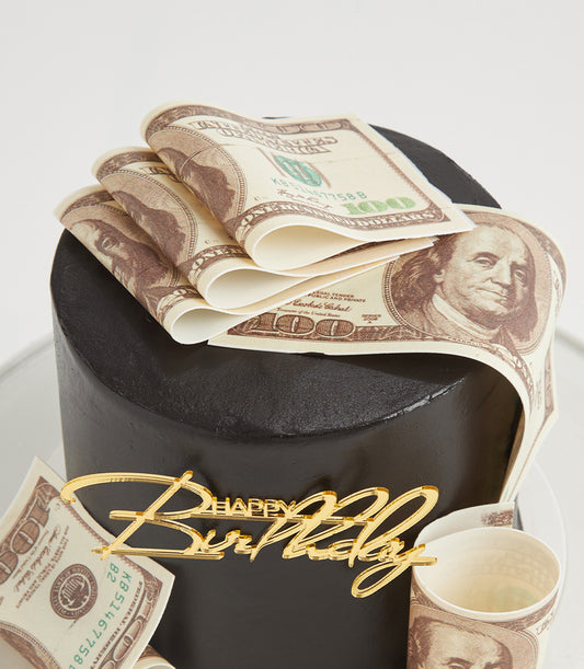Lucky Rich Design birthday cake with edible money decorations and gold Happy Birthday topper on dark grey frosting