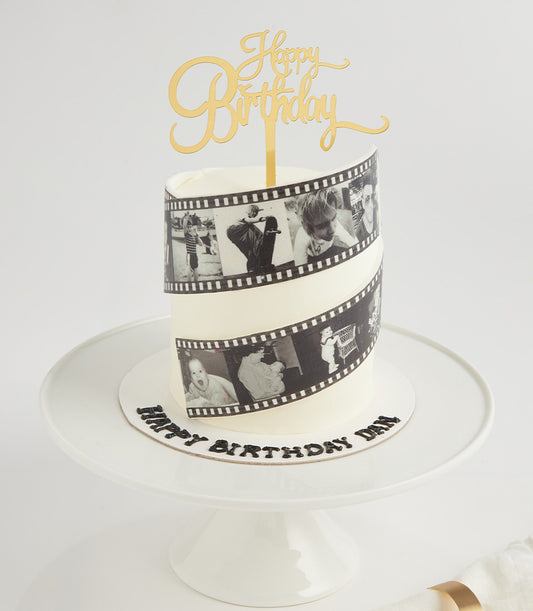 White layer cake with black and white film strip edible photos, gold Happy Birthday topper, personalised for birthday