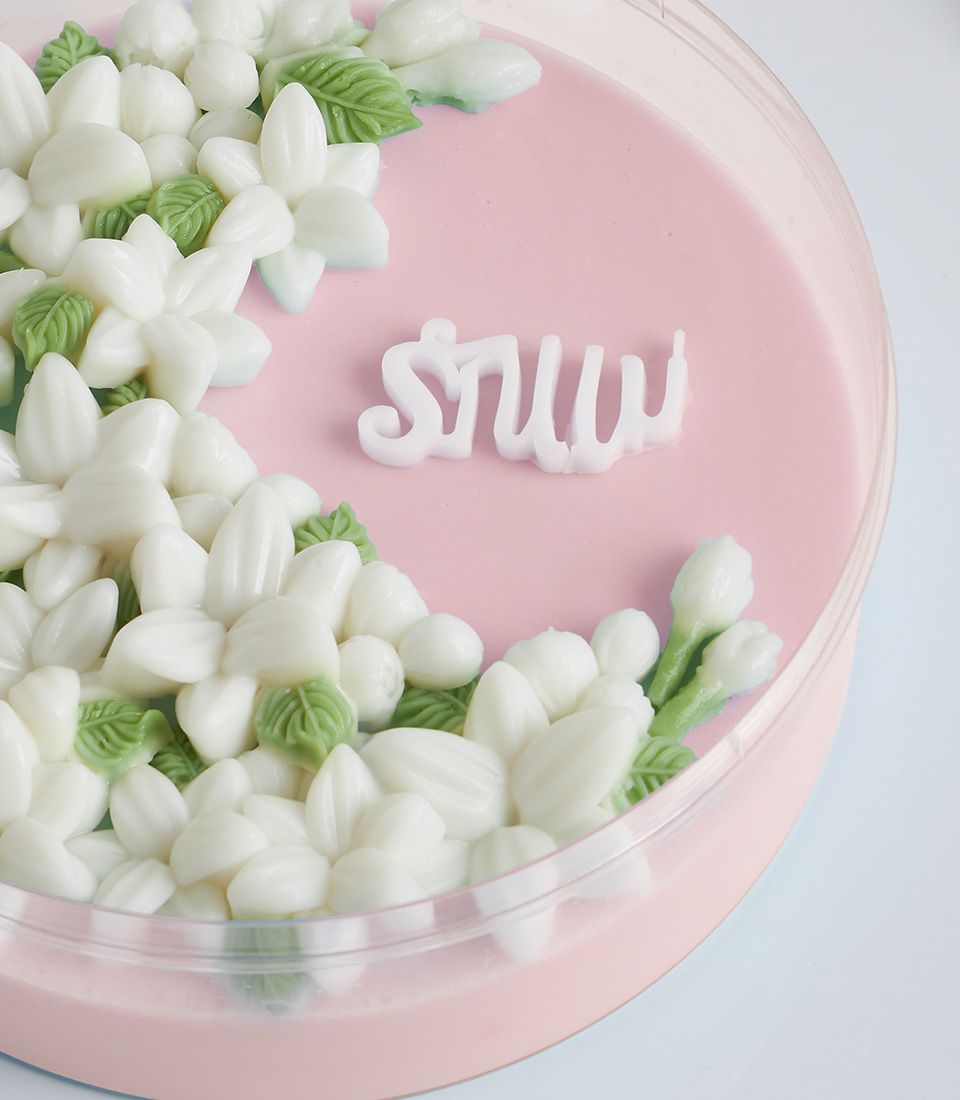 Coconut jasmine flower jelly with white edible blossoms and green leaves, Mother's Day gift