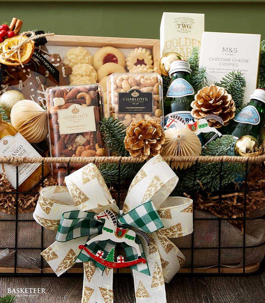 Festive Christmas gift basket with gourmet cookies, nuts, tea, cheese crackers, sparkling water and gold ornaments