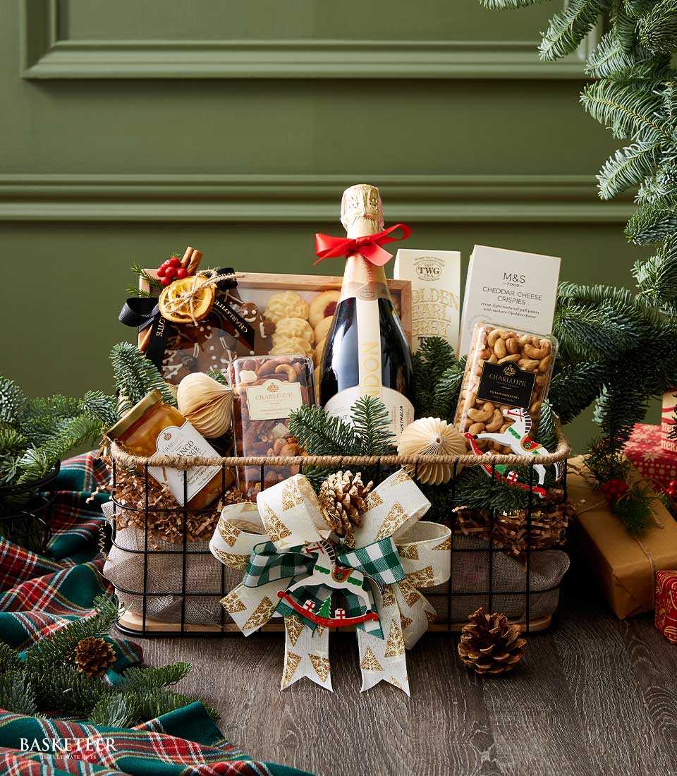 Premium black wire Christmas gift basket with sparkling wine, gourmet nuts, cheese crisps, and festive holiday trimmings