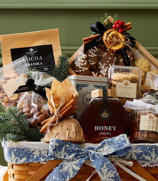 Woven holiday gift basket with gourmet treats, cocoa granola, honey, cookies, and gingerbread decorated with cinnamon and