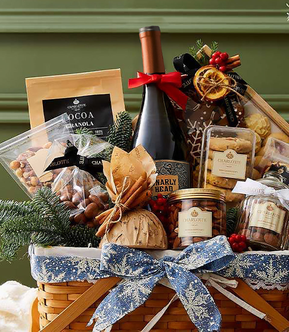 Festive woven gift basket with red wine, gourmet treats, cocoa granola, and holiday spices for Christmas