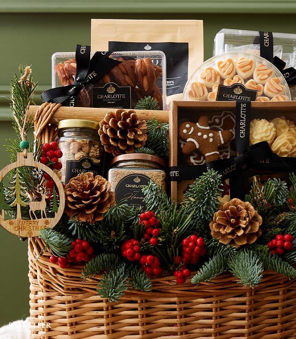 Woven wicker Christmas desserts gift basket with gourmet treats, cookies, nuts, and festive pine decorations