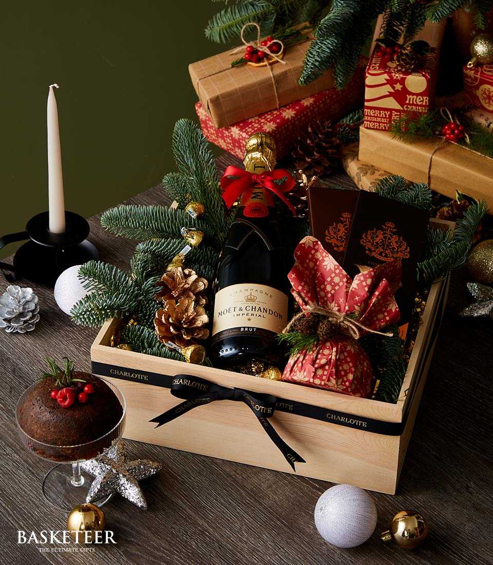 Moët & Chandon champagne Christmas gift set in wooden crate with festive decorations and gourmet treats