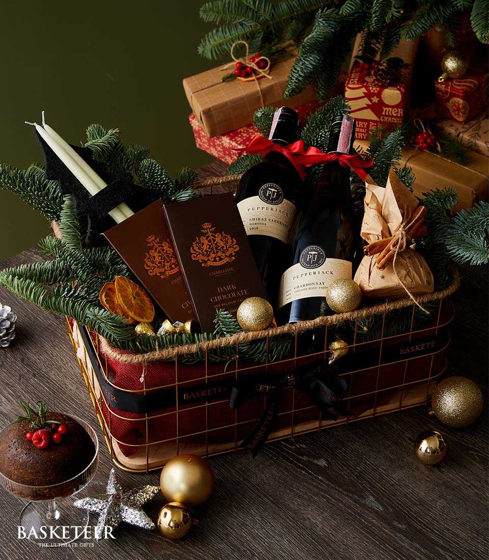 Pepperjack wine and dark chocolate Christmas gift basket with candles, dried citrus, and festive greenery