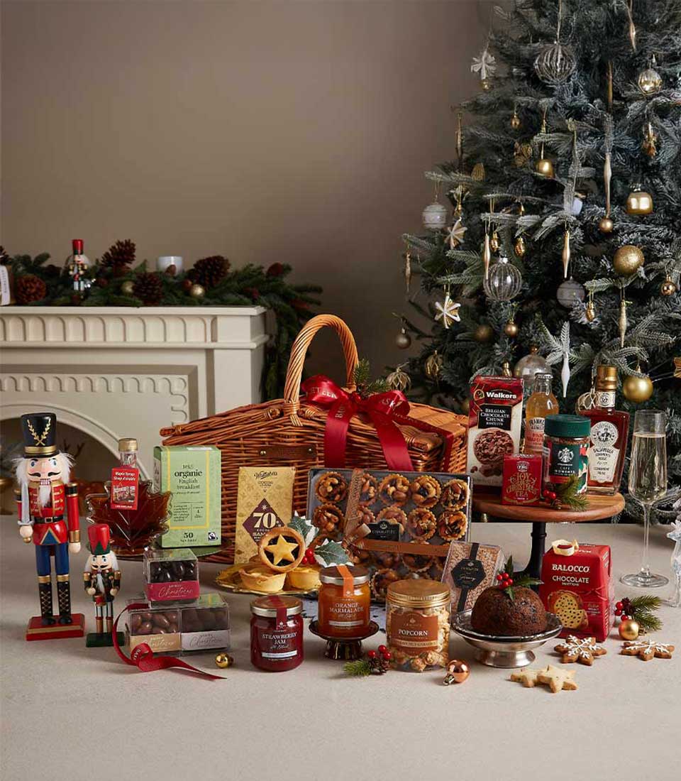 Grand Christmas hamper with gourmet treats, jams, biscuits, and festive baked goods on wicker basket