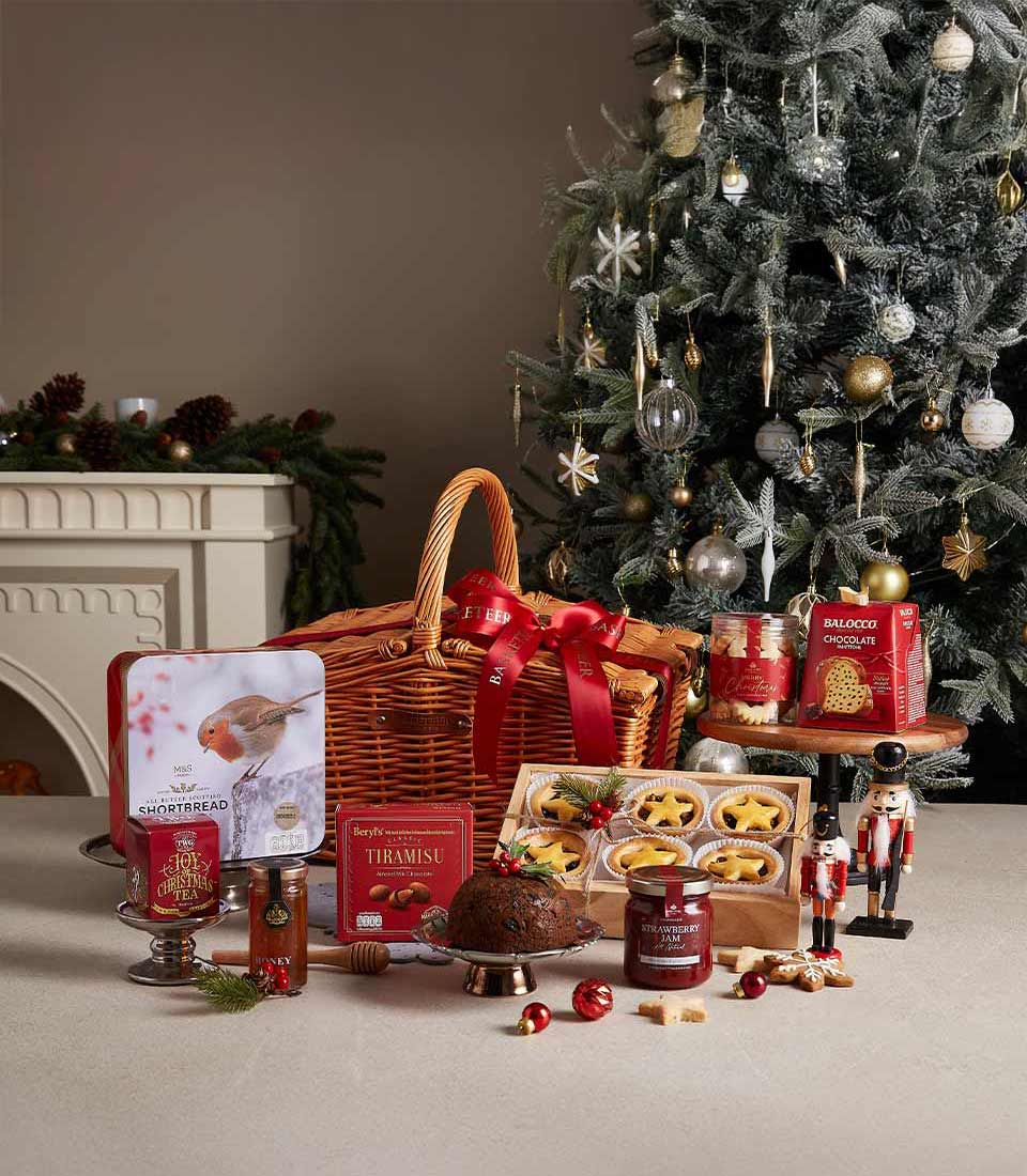 Traditional Christmas hamper with wicker basket, gourmet treats, and festive decorations by Basketeer